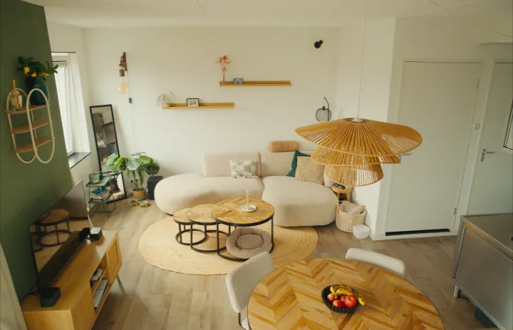 My living room with a light sofa, round tables and a rattan lamp
